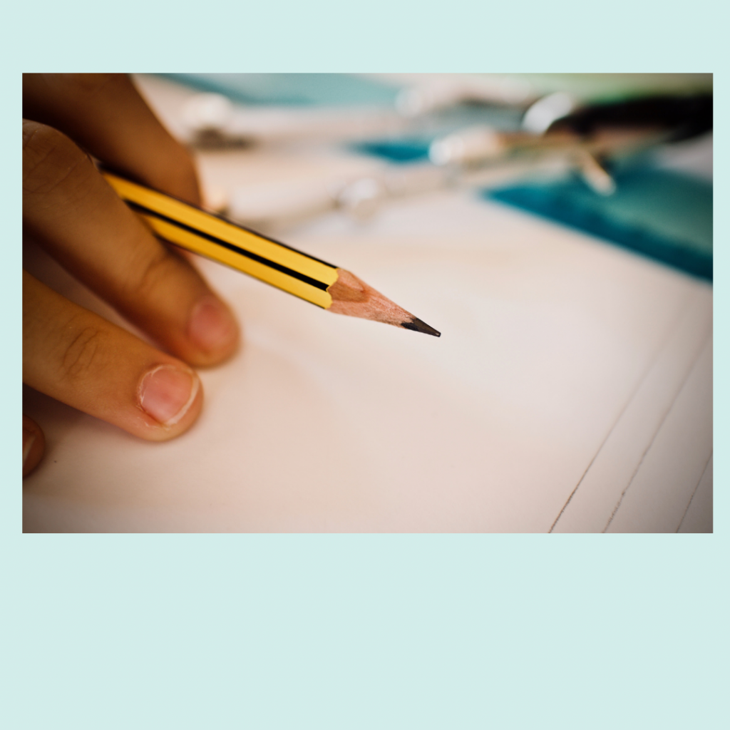 Pencil ready to write on lined paper