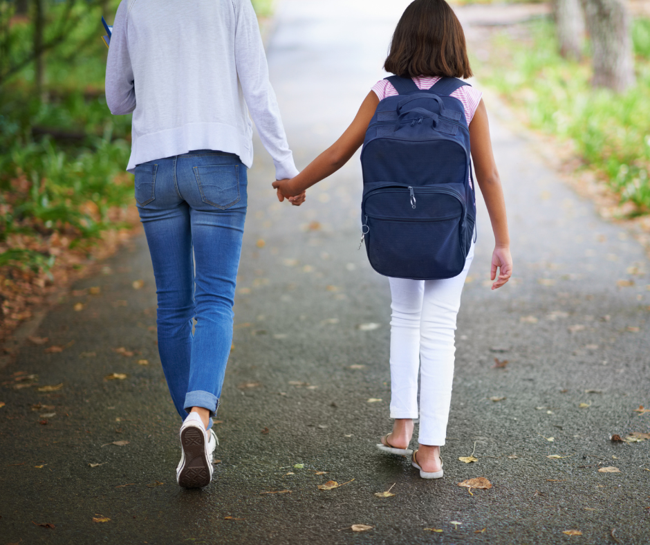 A parent walking a child to school